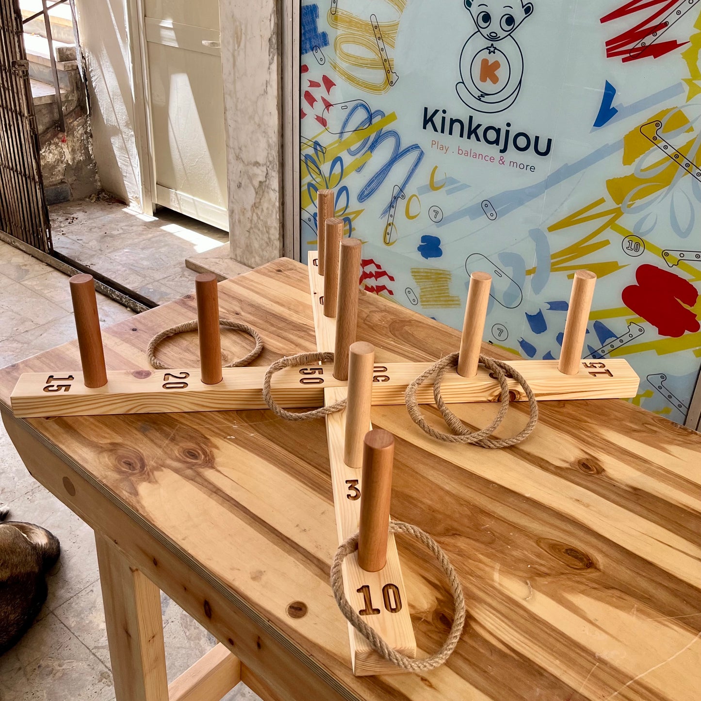 Ring toss throwing game with jute rings.